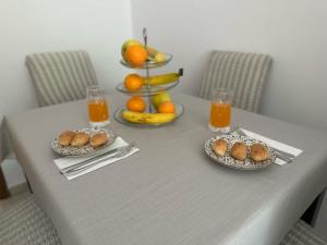 a table with two plates of food and fruit on it at Family apartment Makarska in Makarska