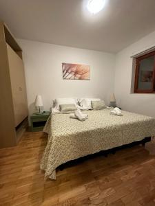 a bedroom with a bed and a wooden floor at Family apartment Makarska in Makarska