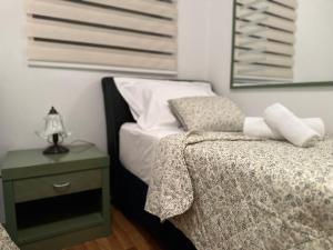 a bedroom with a bed and a table with a lamp at Family apartment Makarska in Makarska