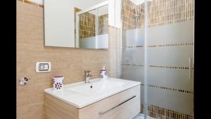 a bathroom with a sink and a shower at B&B Maison Rosetta IUN-E4948 in Nuoro