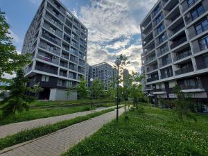 a park with two tall buildings and a street light at INTER EXPO APARTMENT in Sofia