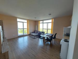 a living room with a table and chairs and a couch at INTER EXPO APARTMENT in Sofia