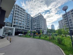 an empty street in a city with tall buildings at INTER EXPO APARTMENT in Sofia