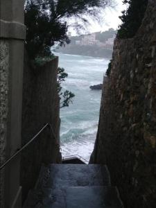 a set of stairs leading down to the ocean at Castiglioncello Suite in Castiglioncello