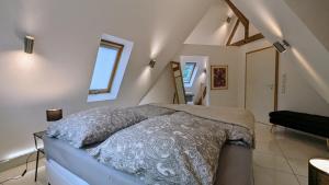 a bedroom with a bed in a attic at WOLKENFREI - ankommen und Zuhause fühlen - Apart-VL in Bad Liebenzell