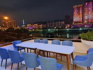 a balcony with tables and chairs and a city skyline at SONG HONG VIEW HOTEL in Lao Cai