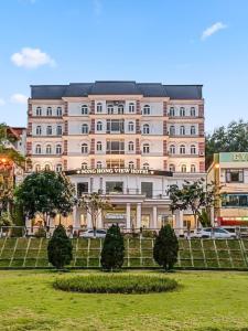 a large building with a park in front of it at SONG HONG VIEW HOTEL in Lao Cai