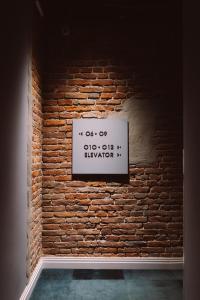 a brick wall with a sign on it at Gruner Hotel in Lviv