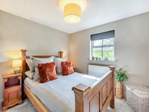 a bedroom with a large bed and a window at Holme House in Eldroth