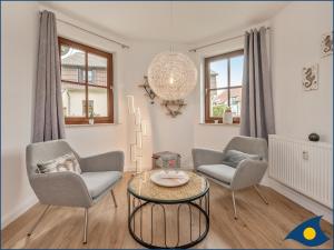 a living room with two chairs and a table at Ferienwohnung Hornig in Garz-Usedom