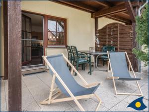 a pair of chairs and a table on a patio at Ferienwohnung Hornig in Garz-Usedom