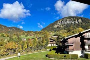 a resort with a mountain in the background at Studio à Praz-sur-Arly in Praz-sur-Arly +19 photos