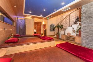 a bedroom with two beds with red pillows at Hotel Wenger Alpenhof in Werfenweng