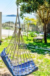 a hammock hanging from a tree in a park at HUT HOUSE Εξοχικό στην παραλία Μ. Άμμος in Skiathos