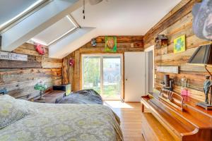 a bedroom with wooden walls and a bed in a room at Windham Mountain Vacation Rental about 3 Mi to Lifts! in Windham