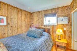 a bedroom with wood paneled walls and a bed at Windham Mountain Vacation Rental about 3 Mi to Lifts! in Windham