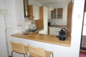 a kitchen with a counter and two chairs in it at Best Apartments Portugal in Lisbon