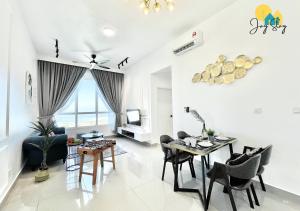 a living room with a dining room table and chairs at Amber Cove l Luxury Seaview 2BR l 6-8pax l GamesRoom l City Centre l Jonker St by Jay Stay in Melaka