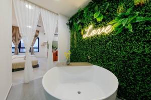 a white toilet in a room with a green wall at The Pano Residence Jalan Ipoh Insta-worthy Bath Tub Studio 浴缸MRT in Kuala Lumpur +59 photos
