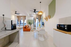 a kitchen and living room with a couch and a table at The Pano Residence Jalan Ipoh Insta-worthy Bath Tub Studio 浴缸MRT in Kuala Lumpur