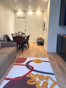 a living room with a couch and a table at 07 Best Flat of Grand Boulevard in Paris