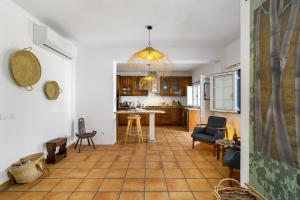 a kitchen and living room with a tiled floor at Comporta Center Villa in Comporta
