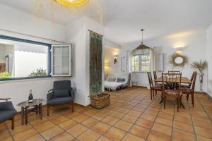 a living room with a table and chairs and a dining room at Comporta Center Villa in Comporta