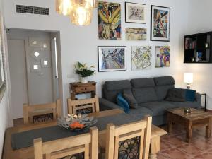 a living room with a couch and a table at Villa Estrella with private pool in Mazarrón