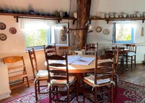 a dining room with a wooden table and chairs at Mühle Beckenkrug in Varchentin