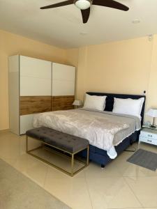 a bedroom with a large bed with a ceiling fan at Apartments Villa Isabella in Opatija +14 photos