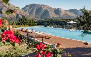 a swimming pool with mountains in the background at Nassibe Estate in Áyios Ioánnis