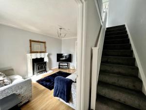 a living room with a staircase and a stair case at House near Swansea & Brecons! in Aberdulais