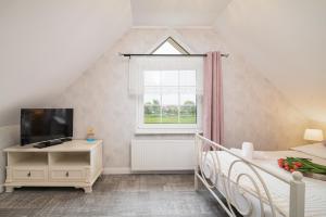 a attic bedroom with a bed and a window at Villa Mare in Łeba