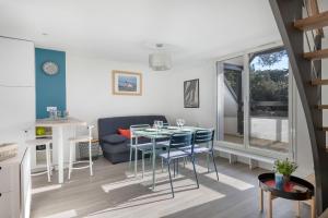 a kitchen and living room with a table and chairs at Appartement vue mer et les pieds dans l'eau! in Saint-Sébastien