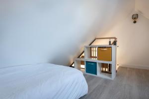 a bedroom with a bed and a dresser with a mirror at Appartement vue mer et les pieds dans l'eau! in Saint-Sébastien
