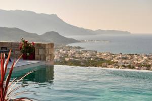a swimming pool with a view of the ocean at Luxury Villa Argi infinity private pool in Kissamos