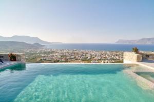 a swimming pool with a view of a city at Luxury Villa Argi infinity private pool in Kissamos