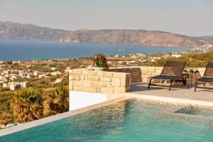 a swimming pool with a view of the water at Luxury Villa Argi infinity private pool in Kissamos