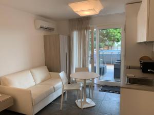 a living room with a couch and a table at AppartArbus white suite in Arbus