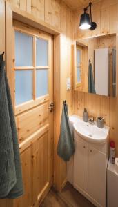 a bathroom with a sink and a mirror at Miło las widzieć in Ciwoniuki +54 photos
