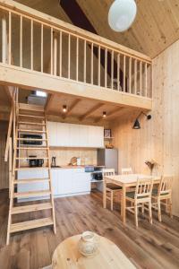 a kitchen and dining room with a loft at Miło las widzieć in Ciwoniuki +57 photos
