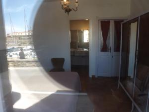a living room with a view of a marina at B&B Il Gatto Pescatore in Stintino