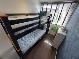 a bunk bed in a room with a window at Perfect Cowes retreat with Hot Tub in Cowes