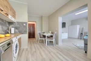 - une cuisine et une salle à manger avec une table et des chaises dans l'établissement Apartament w Górach Wałbrzyskich, à Boguszów-Gorce