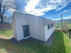 a white building with a door in the grass at Casa en Aldea 20 in Sales