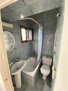 a bathroom with a sink and a toilet and a bath tub at Durmiendo con el mar in Lastres