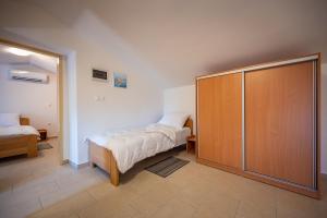 a bedroom with a bed and a sliding glass door at Apartman Vito in Pomer
