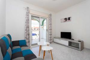 a living room with a couch and a television at CH Buganvillas Ciudad Quesada in Ciudad Quesada