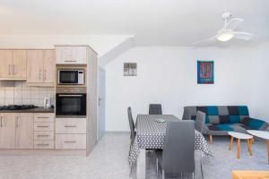 a kitchen and living room with a table and a couch at CH Buganvillas Ciudad Quesada in Ciudad Quesada