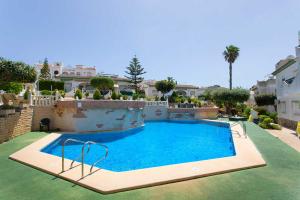 a swimming pool in the middle of a house at CH Buganvillas Ciudad Quesada in Ciudad Quesada
